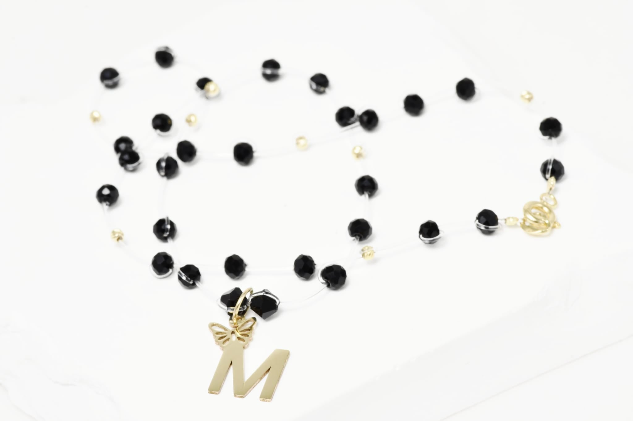 Necklace with Faceted Black Crystal Beads and “M” Initial Pendant