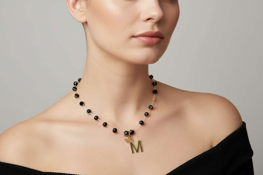Necklace with Faceted Black Crystal Beads and “M” Initial Pendant